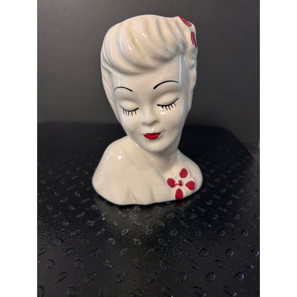 white ceramic lady head vase identified as a vintage "Glamour Girl" planter